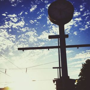 Low angle view of street light against cloudy sky