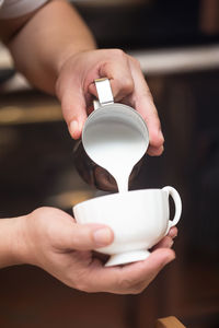 Midsection of woman holding coffee cup