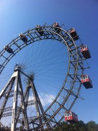 Low angle view of ferris wheel against clear sky