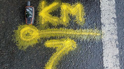 High angle view of yellow sign on street