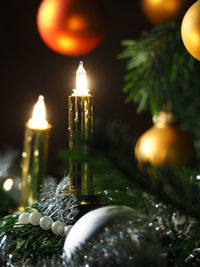 Close-up of illuminated candles on table