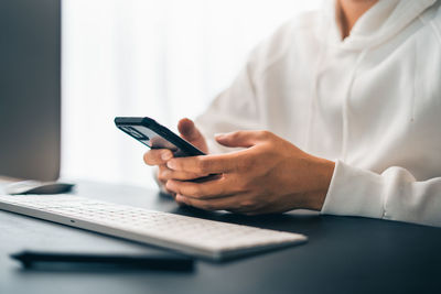 Midsection of businessman using mobile phone