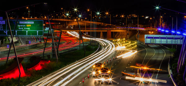Light trails on bridge in city at night