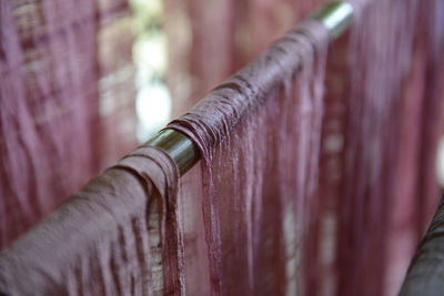 Close-up of fabric hanging on rod in textile industry