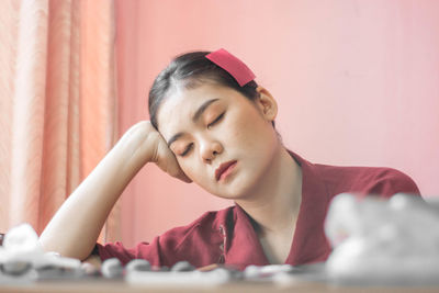 Portrait of woman looking at camera on table