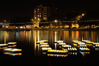 Illuminated cityscape against sky at night