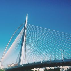 Low angle view of seri wawasan bridge against clear blue sky