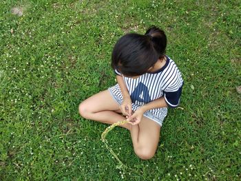 High angle view of woman sitting on field