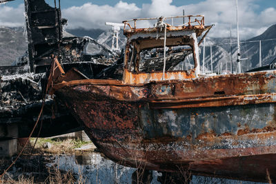 Abandoned boat against sky