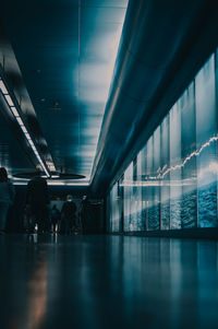 People walking in illuminated modern building