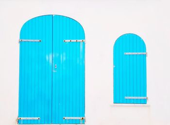 Turquoise wooden door and window in the historic center of alghero sardinia