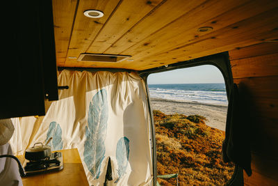 Interior of camper van parked on cliff during sunset in baja, mexico.