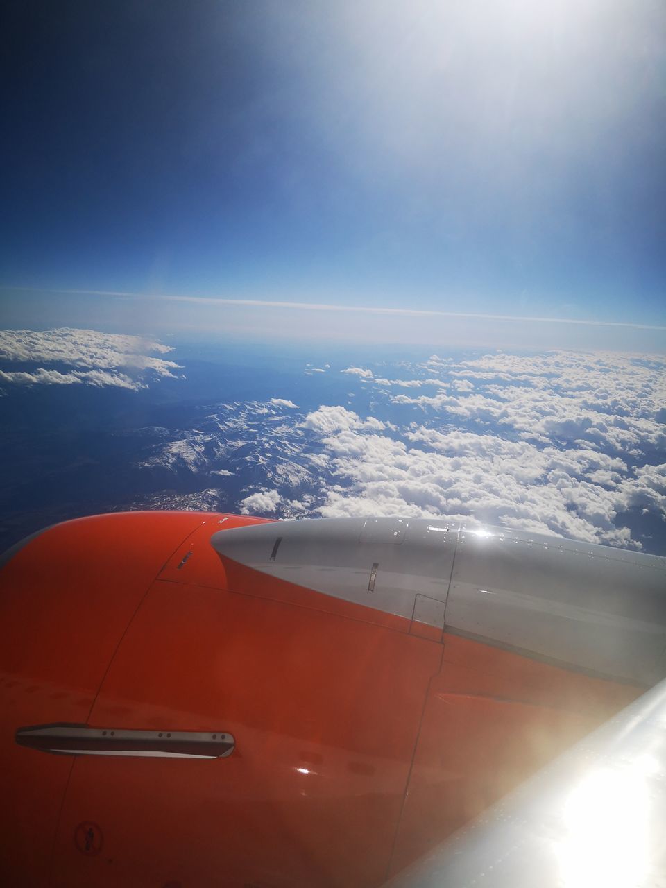 AIRPLANE FLYING OVER CLOUDS