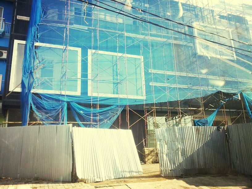 built structure, architecture, empty, absence, chair, indoors, wall - building feature, blue, building exterior, abandoned, sunlight, closed, wall, no people, window, day, house, building, old, metal