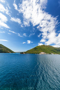 Scenic view of lake against cloudy sky