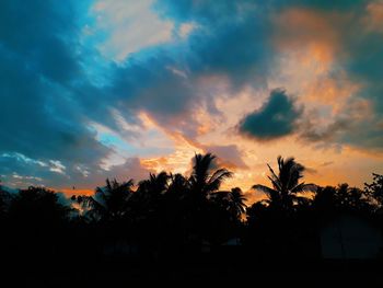 Silhouette trees against sky during sunset