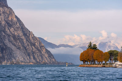 Scenic view of sea and mountains against sky