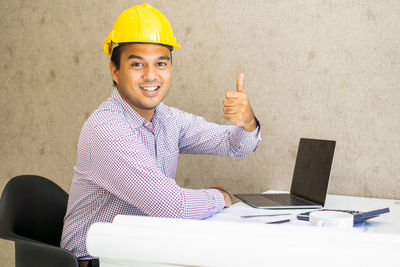 Portrait of smiling man sitting at table