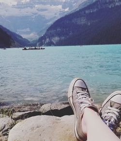 Low section of person relaxing in lake