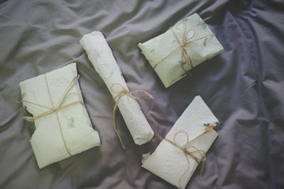 High angle view of wrapped gifts on textile