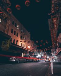 Illuminated city street and buildings at night