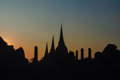 Silhouette temple against sky during sunset