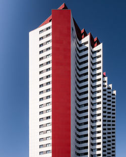 Low angle view of modern buildings against blue sky