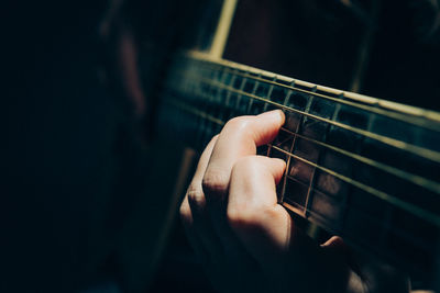 Close-up of man playing guitar