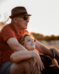 Midsection of couple wearing hat