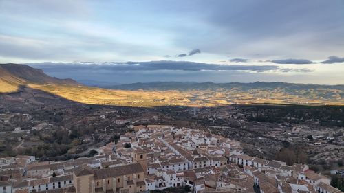 High angle view of town against cloudy sky