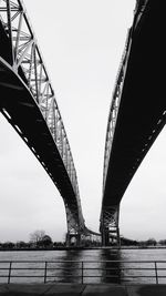 Low angle view of suspension bridge against sky