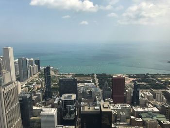 High angle view of buildings by sea against sky