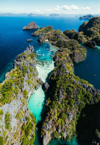 High angle view of rocks by sea against sky