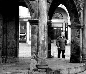 Rear view of man standing outside building