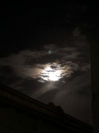 Low angle view of silhouette building against sky at night