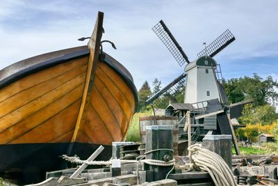 Traditional windmill on landscape against sky