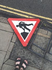 Low section of men at work signboard on footpath