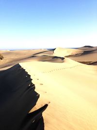 Scenic view of desert against clear sky