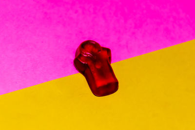 High angle view of bottle in glass on table against wall