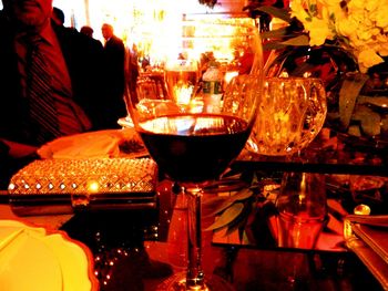 Close-up of wine glasses on table in restaurant