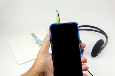 Close-up of hand holding mobile phone