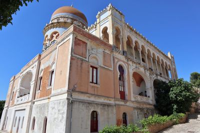 Low angle view of building against clear blue sky