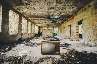 Old television set in abandoned house