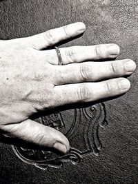 High angle view of hands on finger