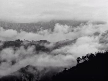 Scenic view of mountains against cloudy sky