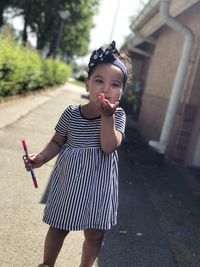 Portrait of a girl standing against blurred background