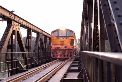 Train on bridge against sky