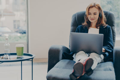 Young woman using laptop at home