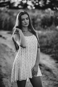 Portrait of young woman standing at beach