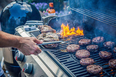 Man preparing food on barbecue grill